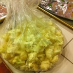 Put the cut cauliflower in a produce bag and shake to get salt and pepper or other seasoning onto each of the pieces.