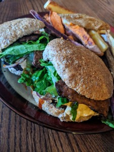 Load up J & T's Beloved Black Bean Burgers with lots of fresh greens, onions, avocado, Josie's Creamy Sriracha Queso, garlic mushrooms and more! 